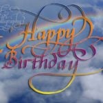 Flourished Happy Birthday calligraphy with rainbow background