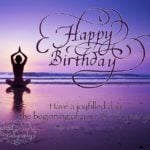 Flourished Happy Birthday calligraphy with yoga at the beach background